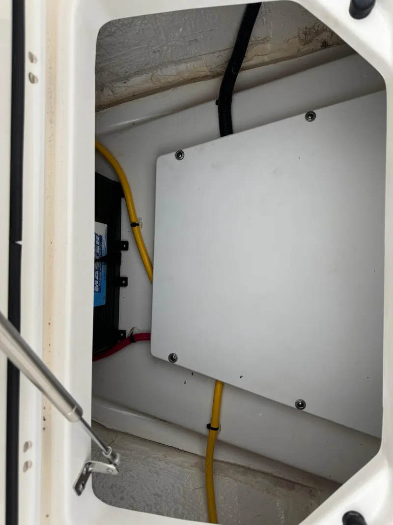 Slide: The Image of 2023 Pursuit S 328 Sport boat compartment with wiring and battery. - 42