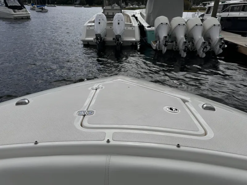 Slide: The Image of 2023 Pursuit S 328 Sport boat docked with multiple outboard engines. - 43