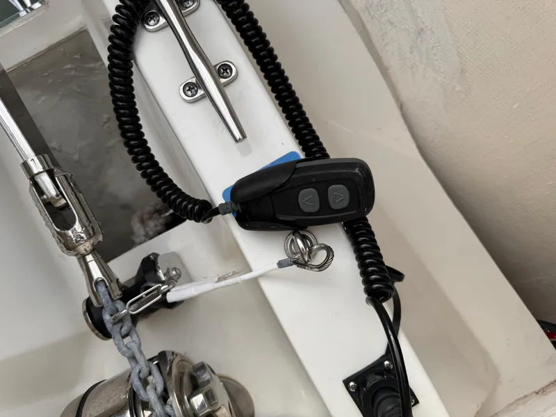 Slide: The Image of Close-up of 2023 Pursuit S 328 Sport boat control panel with coiled cable and buttons. - 45