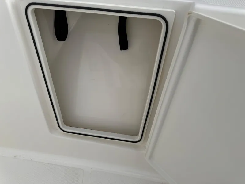 Slide: The Image of Open storage compartment on 2023 Pursuit S 328 Sport boat. - 47