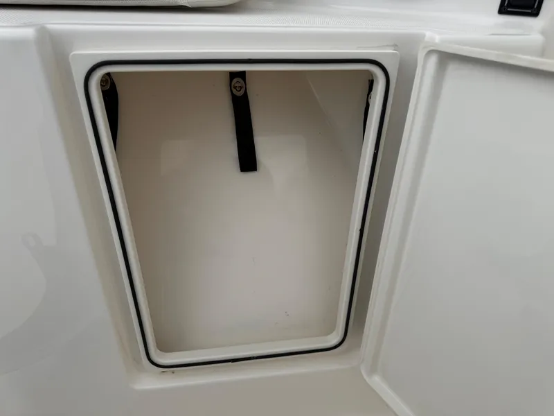 Slide: The Image of Open storage compartment on 2023 Pursuit S 328 Sport boat. - 48