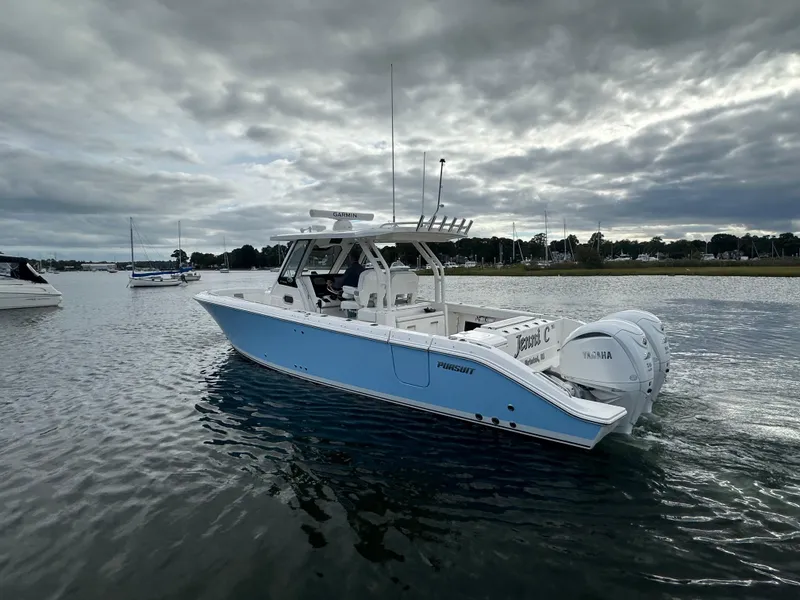 Slide: The Image of 2023 Pursuit S 328 Sport boat on calm water under cloudy sky. - 7