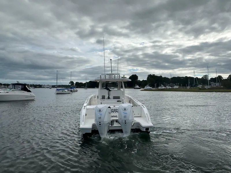 Slide: The Image of 2023 Pursuit S 328 Sport boat on a cloudy day in a marina. - 8