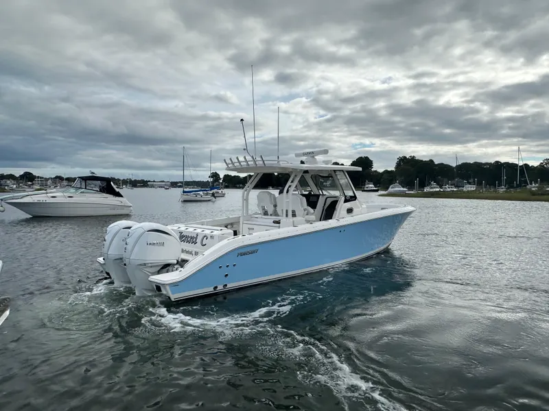 Slide: The Image of 2023 Pursuit S 328 Sport boat cruising on a cloudy day. - 9