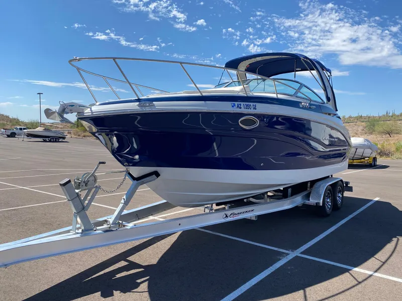 Slide: The Image of 2022 Crownline 264 CR boat on trailer in sunny parking lot. - 11