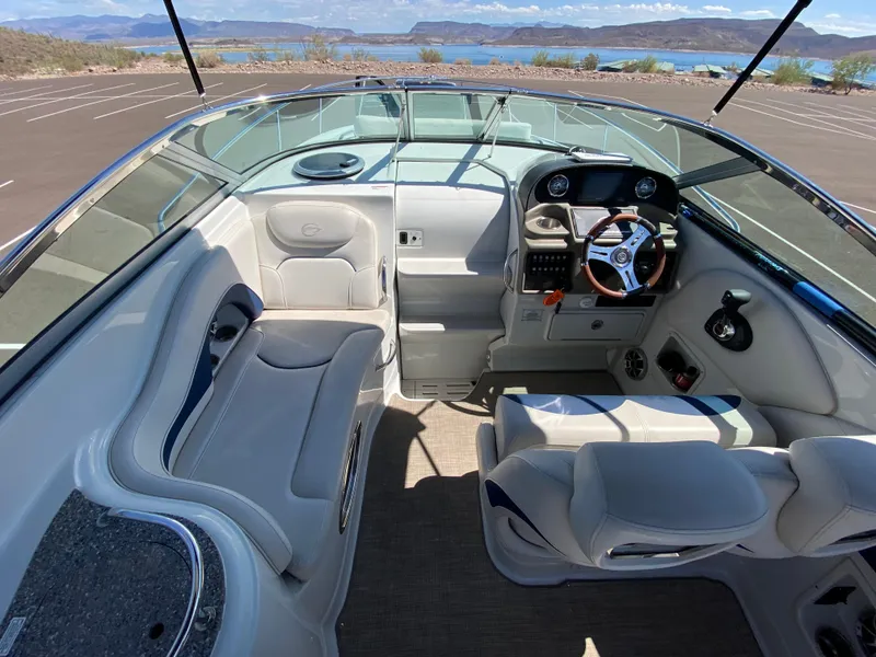 Slide: The Image of Interior of 2022 Crownline 264 CR boat with seating and steering wheel. - 17