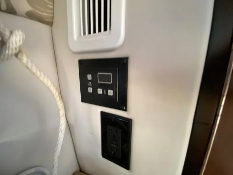 Slide: The Image of Control panel and outlet inside 2022 Crownline 264 CR boat cabin. - 21