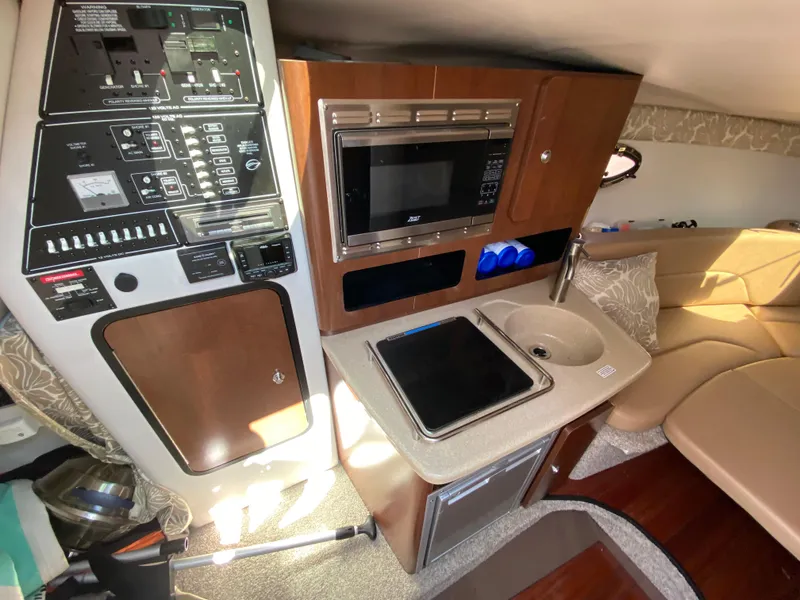 Slide: The Image of 2022 Crownline 264 CR cabin interior with kitchenette and control panel. - 24