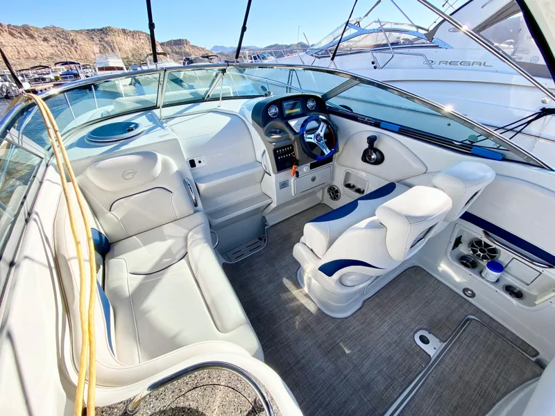 Slide: The Image of 2022 Crownline 264 CR boat interior with modern dashboard and seating. - 29