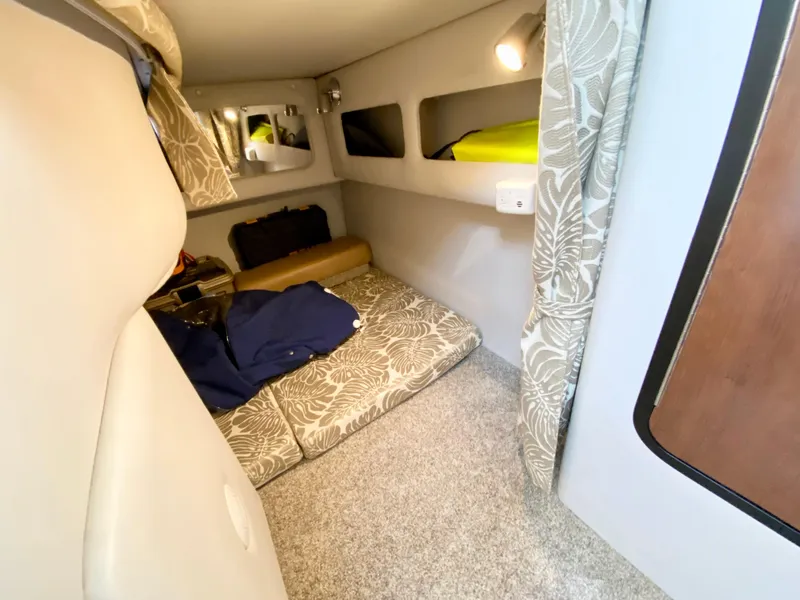 Slide: The Image of 2022 Crownline 264 CR cabin interior with cozy bedding and modern design. - 34