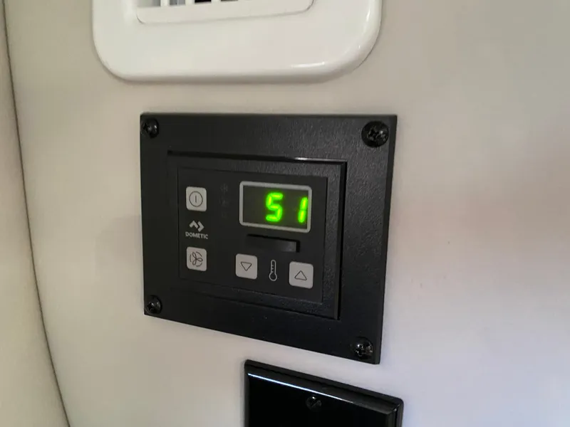 Slide: The Image of Digital control panel on 2022 Crownline 264 CR boat displaying temperature. - 37