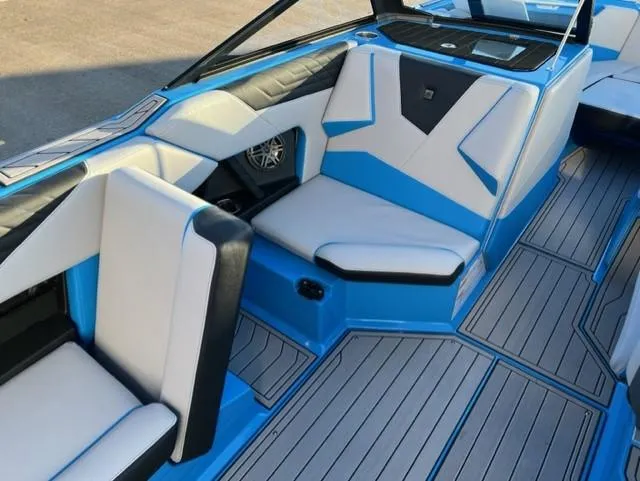 Slide: The Image of 2023 Nautique S23 boat interior with blue and white seating and sleek design. - 12
