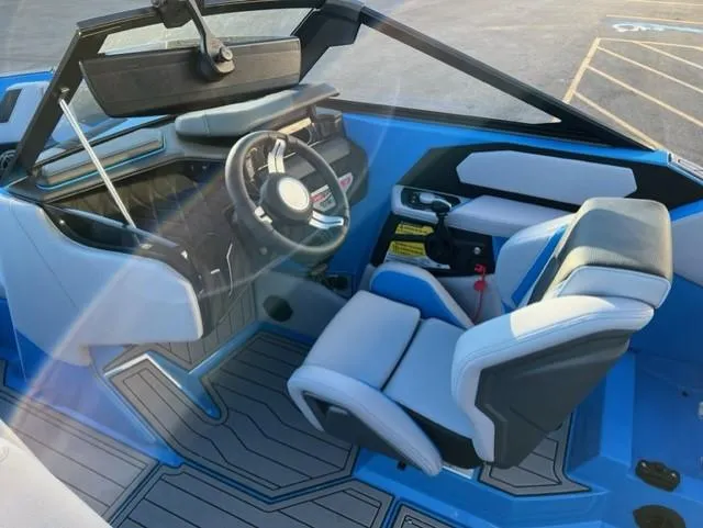 Slide: The Image of 2023 Nautique S23 boat interior with modern steering and seating. - 13