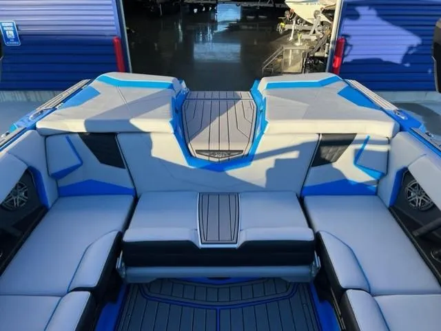 Slide: The Image of 2023 Nautique S23 boat interior with blue and gray seating. - 15