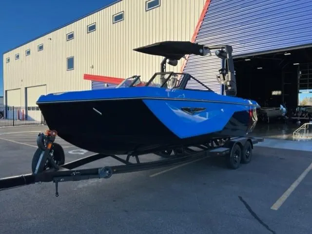 Slide: The Image of 2023 Nautique S23 boat on trailer outside a warehouse. - 3