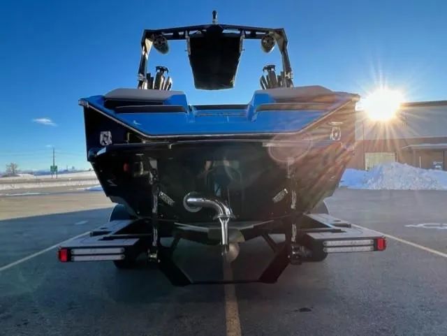 Slide: The Image of 2023 Nautique S23 boat rear view with sunlit background. - 5