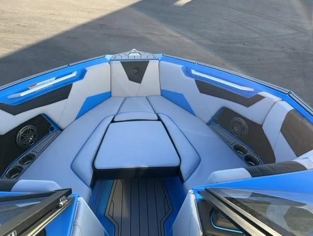 Slide: The Image of 2023 Nautique S23 boat interior with blue and white seating, modern design. - 9