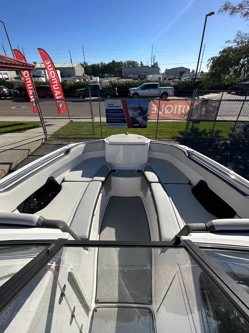 Slide: The Image of 2023 Yamaha AR250 jet boat interior with seating, displayed outdoors. - 13