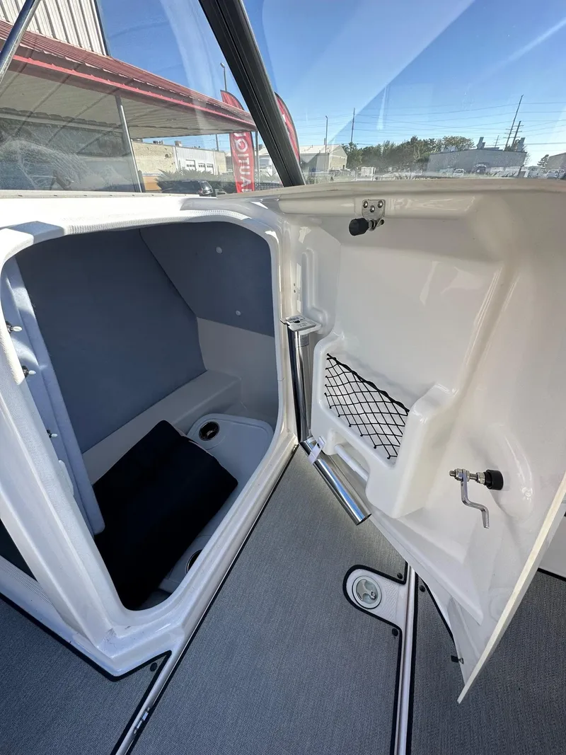 Slide: The Image of 2023 Yamaha AR250 jet boat interior storage compartment with open door. - 18