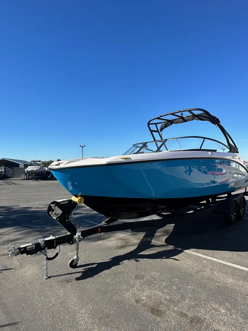 Slide: The Image of 2023 Yamaha AR250 jet boat on trailer under clear blue sky. - 5