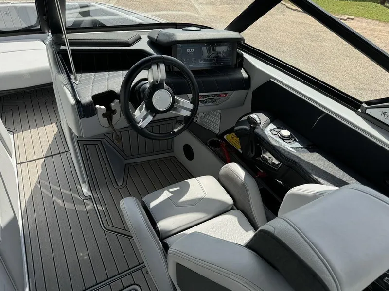 Slide: The Image of 2023 Nautique Super Air Nautique G23 boat interior with modern dashboard and steering wheel. - 4