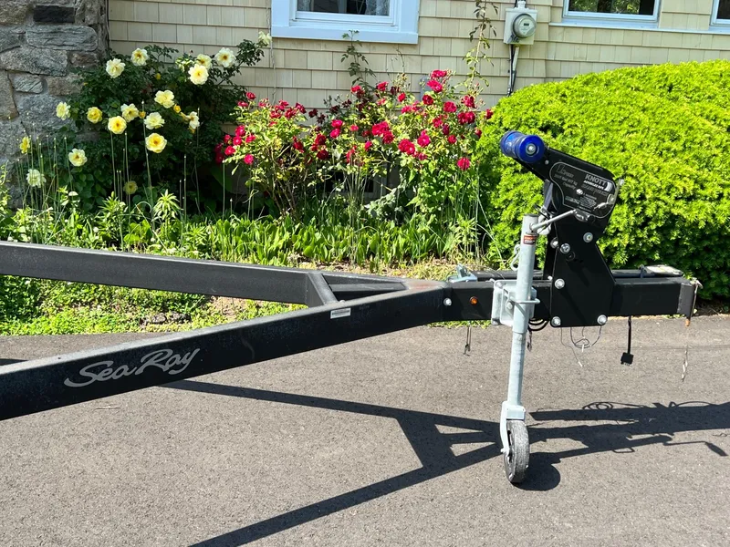 Slide: The Image of Trailer for 2006 Sea Ray 200 Sundeck, parked on driveway with garden background. - 5