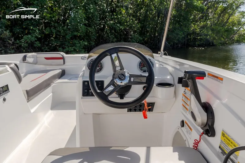 Slide: The Image of 2023 Hurricane SunDeck Sport 205 OB boat interior with steering wheel and controls. - 8