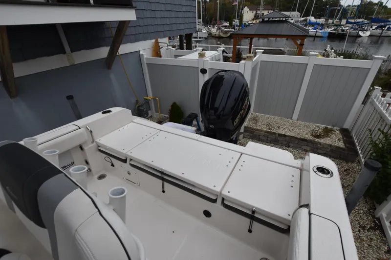 Slide: The Image of 2023 Robalo R230 Center Console boat with outboard motor, docked near marina. - 16