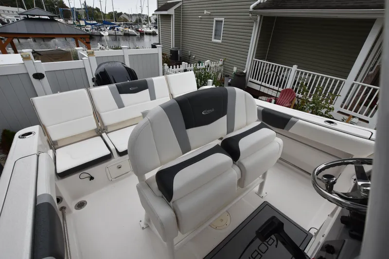 Slide: The Image of 2023 Robalo R230 Center Console boat interior with seating and steering wheel. - 19