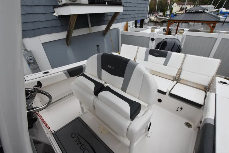 Slide: The Image of 2023 Robalo R230 Center Console boat interior with seating and steering wheel. - 20