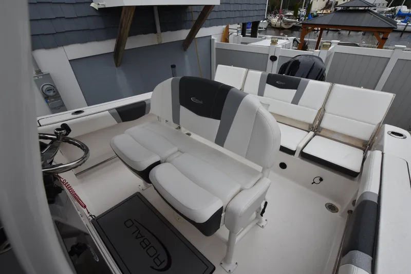 Slide: The Image of 2023 Robalo R230 Center Console boat interior with seating and steering wheel. - 21