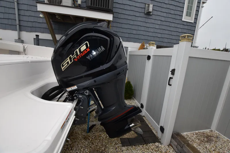 Slide: The Image of 2023 Robalo R230 Center Console with Yamaha SHO outboard motor in a residential setting. - 5