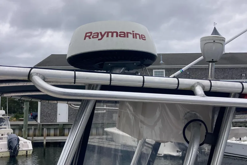 Slide: The Image of Grady-White 222 FISHERMAN 2006 with Raymarine radar, docked under cloudy skies. - 11