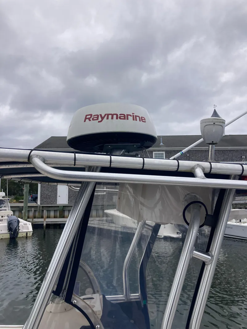Slide: The Image of 2006 Grady-White 222 Fisherman boat with Raymarine radar, docked under cloudy skies. - 6