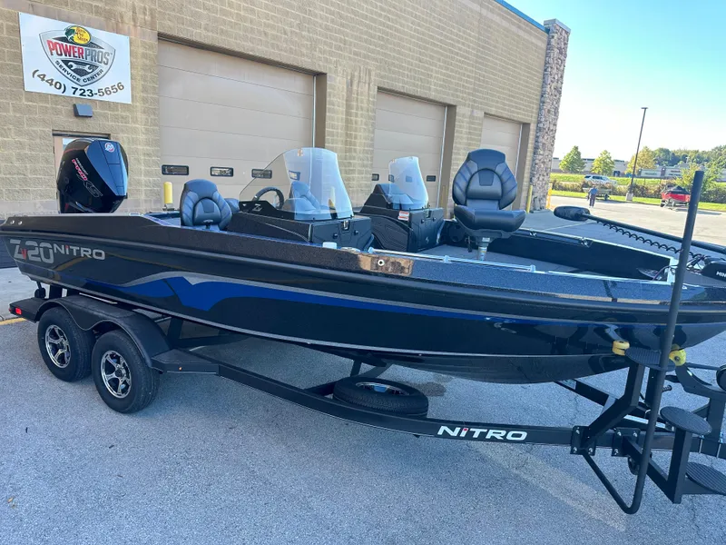 Slide: The Image of 2024 Nitro ZV20 boat on trailer outside a garage. - 3