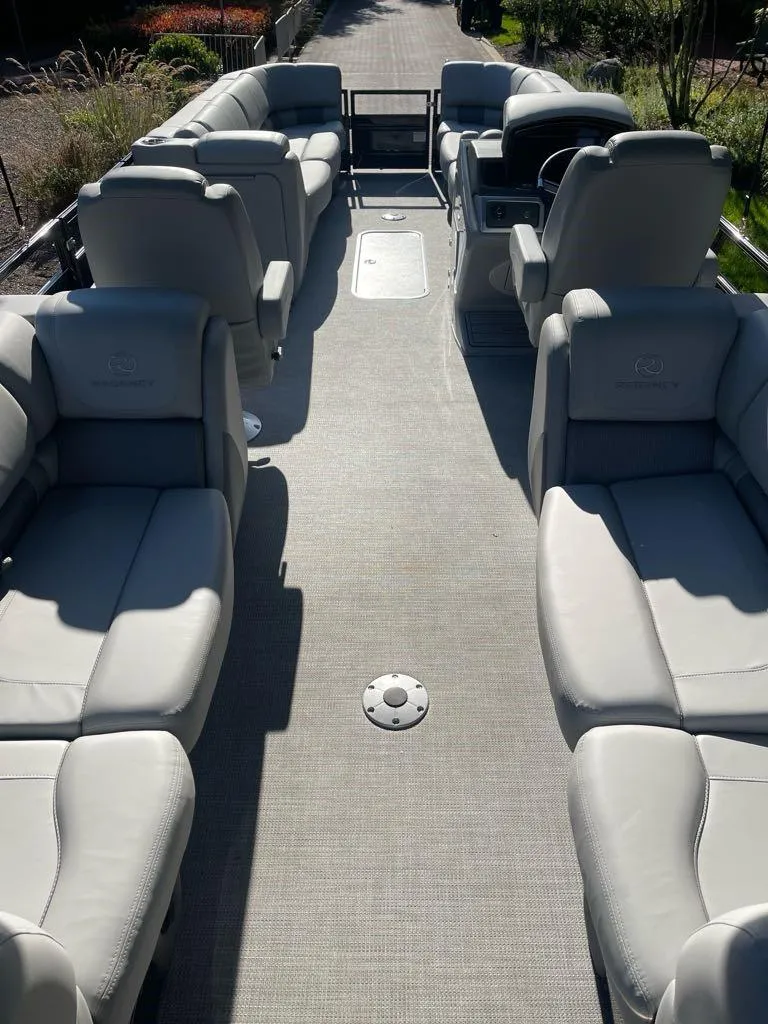 Slide: The Image of 2024 Regency 250 LE3 pontoon boat with spacious seating and modern design. - 3