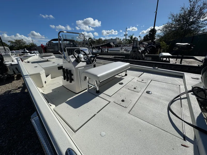 Slide: The Image of 2024 Ranger RB200 boat with console and seating, parked outdoors under a clear sky. - 2