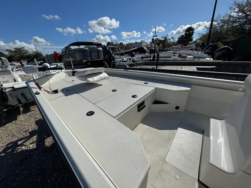 Slide: The Image of 2024 Ranger RB200 boat, spacious deck, parked outdoors under a clear sky. - 3