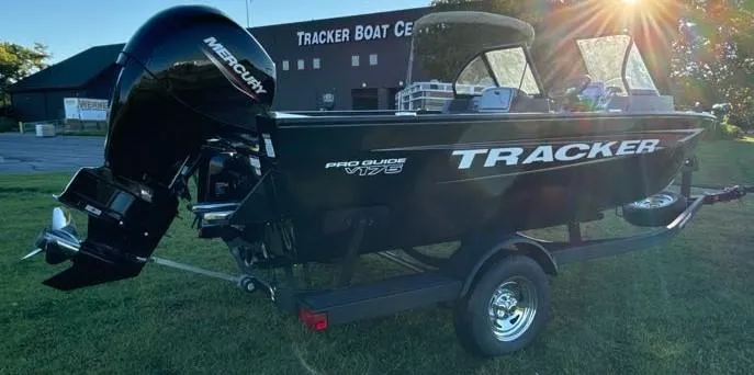 Slide: The Image of 2025 Tracker Pro Guide V-175 Combo boat with Mercury engine in sunlight. - 3