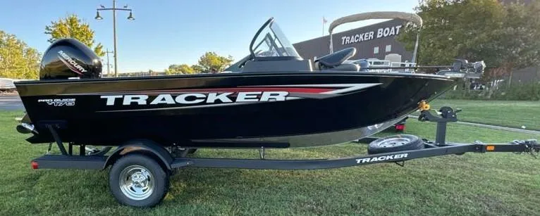Slide: The Image of 2025 Tracker Pro Guide V-175 Combo boat on trailer, parked on grass. - 4