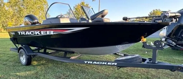 Slide: The Image of 2025 Tracker Pro Guide V-175 Combo boat on trailer, parked on grass. - 5