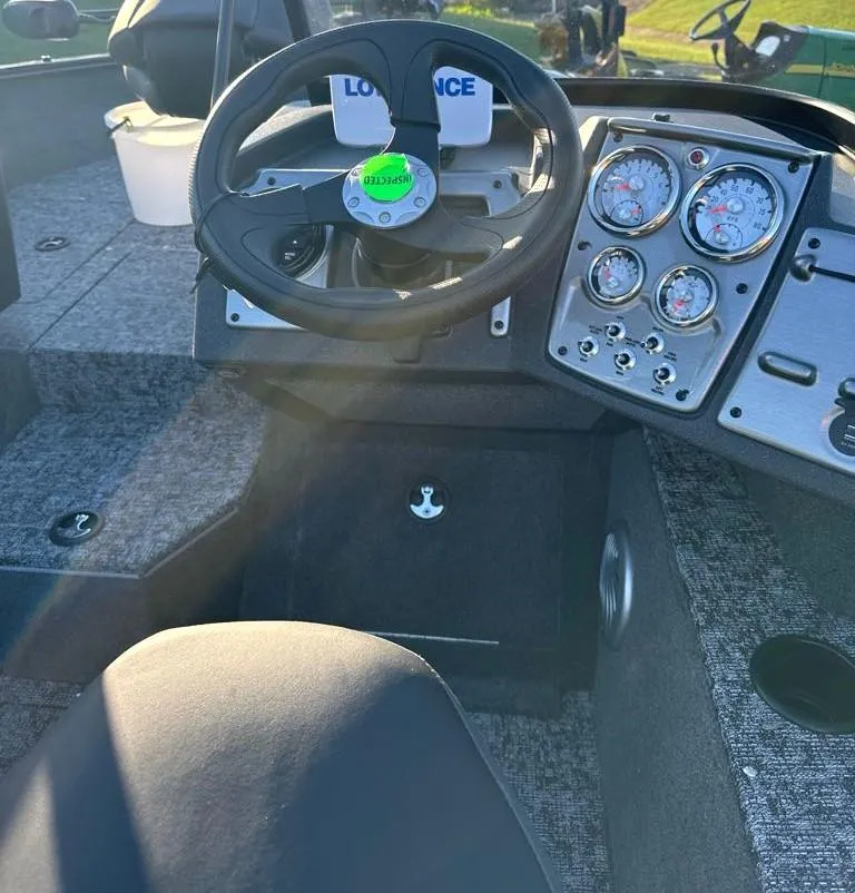 Slide: The Image of 2025 Tracker Pro Guide V-175 Combo boat dashboard with steering wheel and gauges. - 6