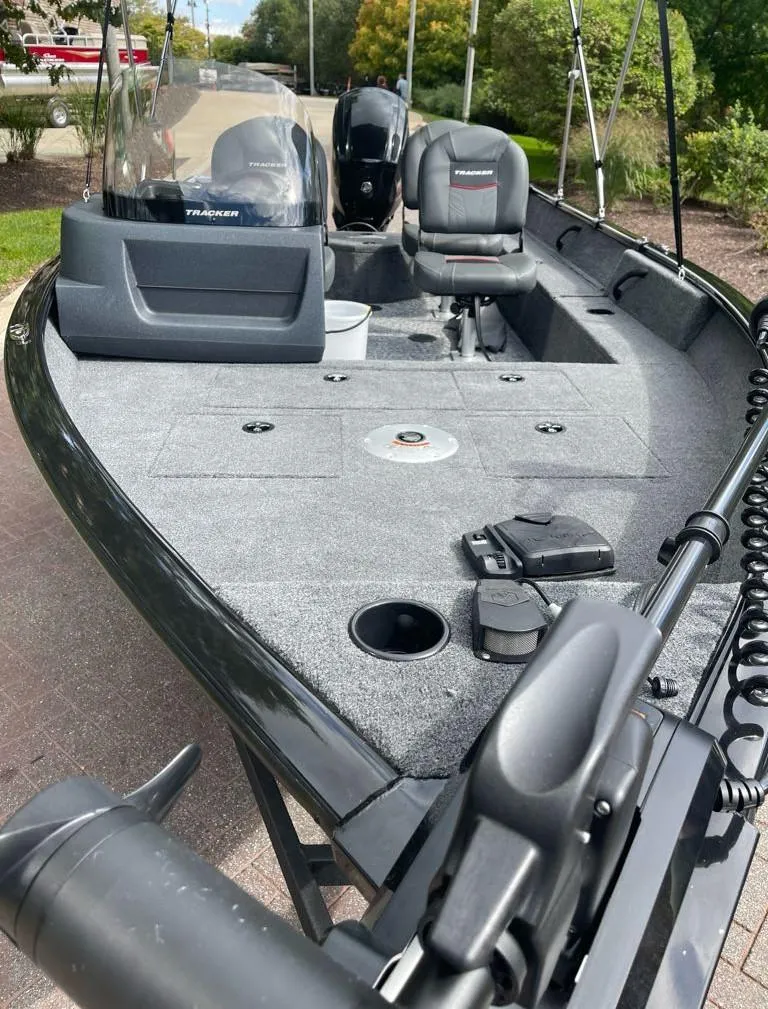 Slide: The Image of 2025 Tracker Pro Guide V-16 SC fishing boat with modern seating and equipment. - 2