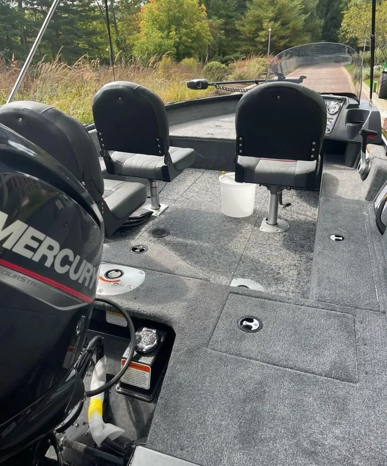 Slide: The Image of 2025 Tracker Pro Guide V-16 SC fishing boat interior with Mercury engine. - 3