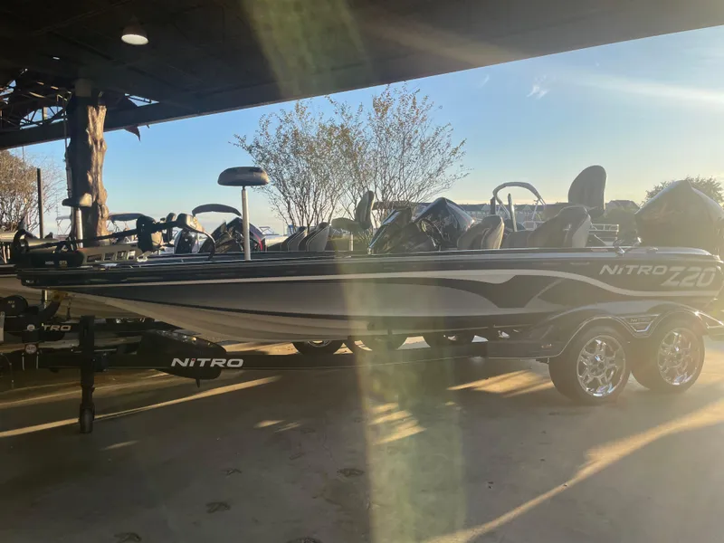 Slide: The Image of 2023 Nitro Z20 boat under a canopy with sunlight streaming through. - 1