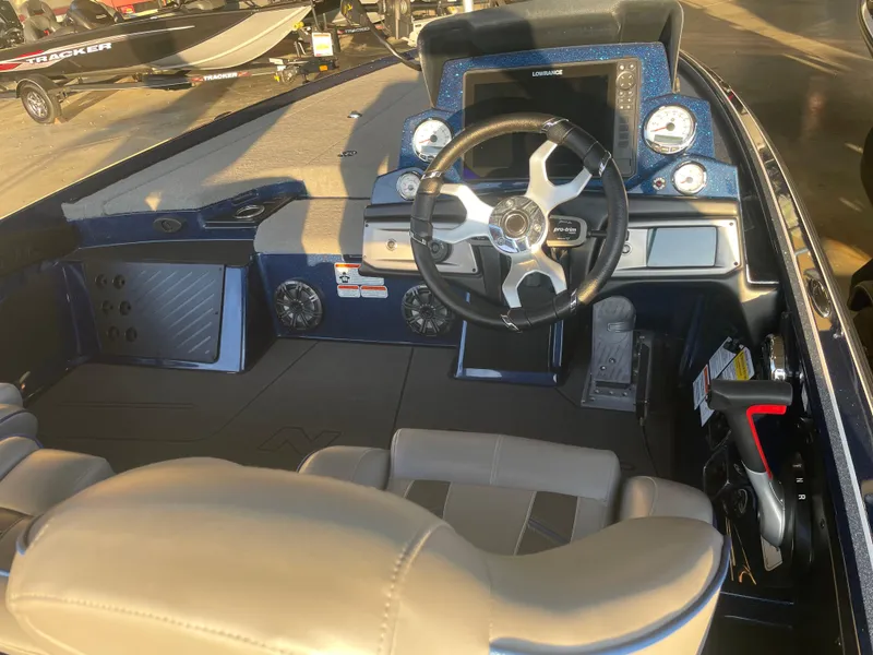 Slide: The Image of 2023 Nitro Z20 boat interior with steering wheel and dashboard controls. - 2