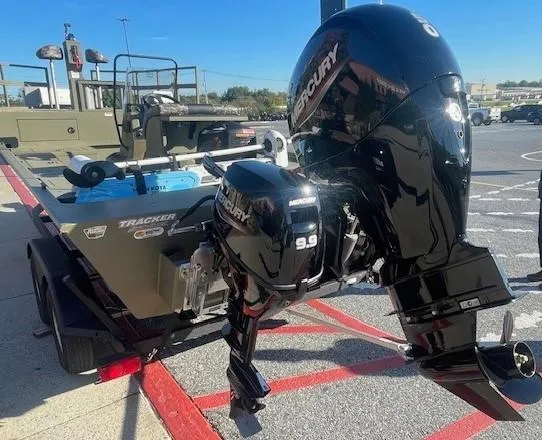 Slide: The Image of 2025 Tracker Grizzly 2072 CC Sportsman Kicker boat on trailer outside dealership. - 2