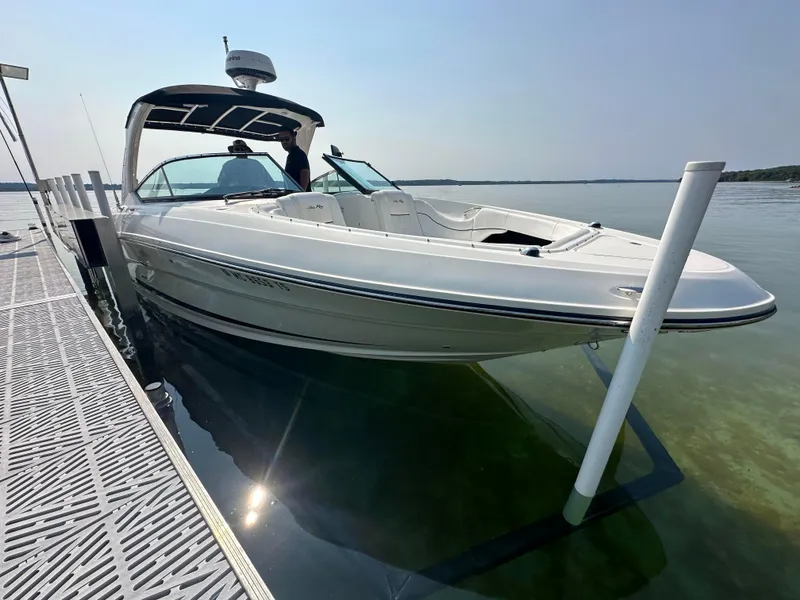Slide: The Image of 2015 Sea Ray 300 SLX boat docked on calm water. - 0