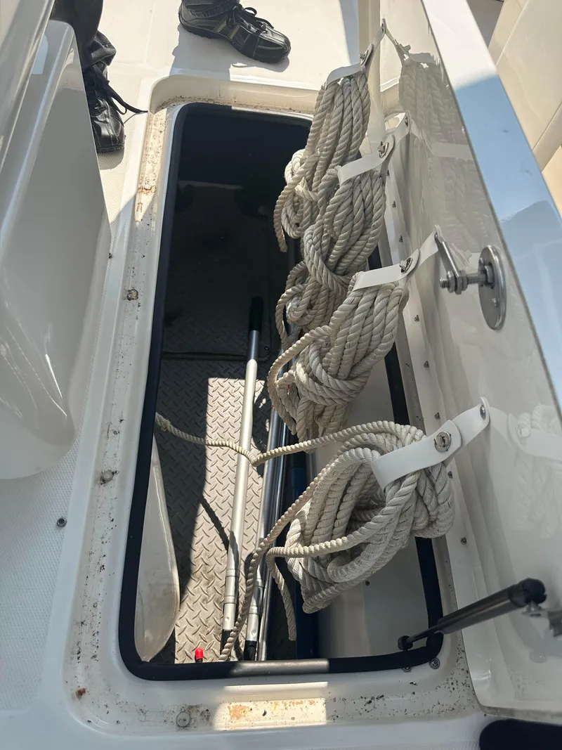 Slide: The Image of Storage compartment on a 2015 Sea Ray 300 SLX boat with coiled ropes. - 10