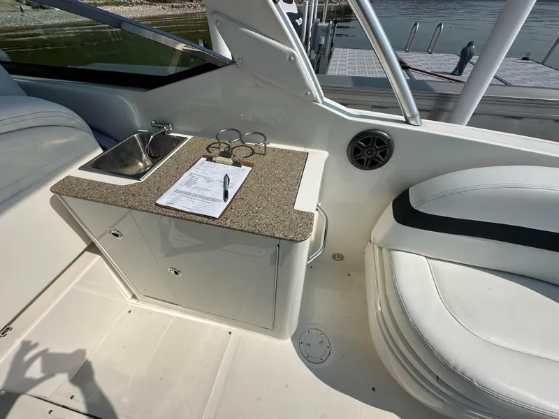 Slide: The Image of Interior of 2015 Sea Ray 300 SLX boat with sink and seating area. - 11